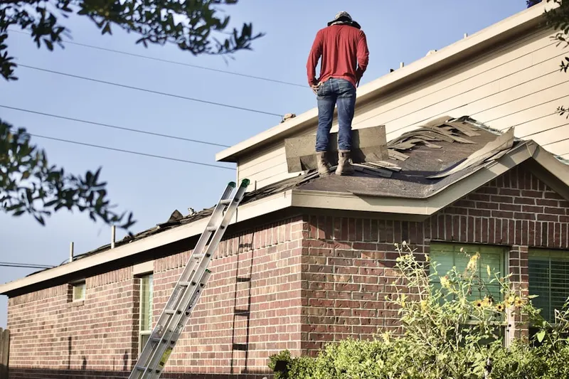 Professional roofer working on a residential roof in Shepherd Plantation